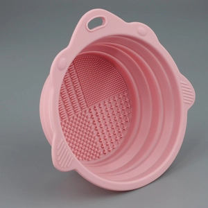 Macro detail of foldable pink silicone makeup brush cleaning bowl with varied textures