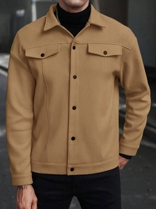 Detail of camel wool-blend texture on a men's lapel jacket with refined stitching