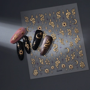 Detailed view of 3D gold snake and celestial nail art stickers on various sample nails