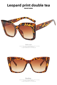 Detail of oversized retro cat eye sunglasses with leopard print frame and brown gradient lenses