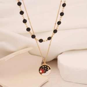 Double-layered gold necklace featuring black beads and a star-moon cloud round pendant