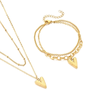 18K gold plated heart necklace and bracelet set with hammered texture on white background