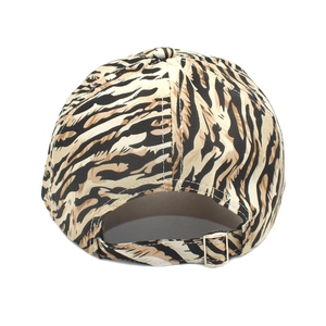 Detail of adjustable strap and animal print pattern on back of baseball cap