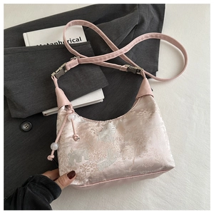 Pink jacquard silk handbag with leather strap on a stylish lifestyle background