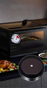 Detail showing magnetic backing of a mechanical silver timer attached to an oven