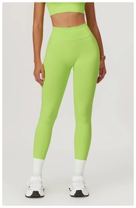 Detail of high-waist neon green seamless yoga leggings with wide ribbed waistband