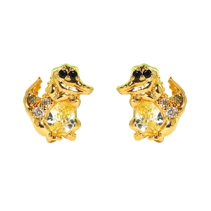 Detailed close-up of golden dinosaur earrings with yellow zircon and crystal accents