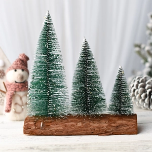 Three snowy cedar mini Christmas trees on a wooden base for festive tabletop decoration