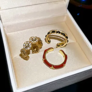 Three elegant 14k gold-plated open rings with zircon and enamel in a jewelry box
