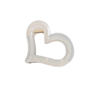 Elegant hollow heart hair claw clip in translucent milky white resin with gold spring