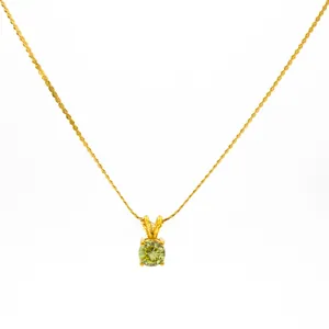 Close-up of golden rope chain necklace with light green birthstone pendant and 4-prong setting