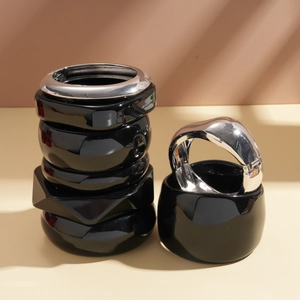 Minimalist resin and silver metal chunky bracelet set stacked in soft natural light