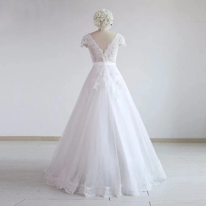 Elegant white A-line wedding dress with lace bodice, deep V-back, and long tulle skirt