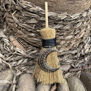 Detail of wicca mini broom car charm with silver moon pendant and natural plant fibers