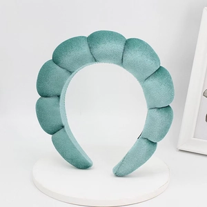 Detail view of thick velvet sponge headband with pleated design in seafoam green