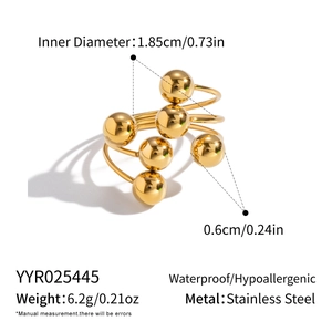 Detailed view of 0.6cm golden stainless steel beads arranged on an open ring