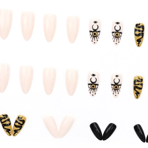 Almond-shaped press-on nails featuring moon, stars, snakes, and minimalist solid colors