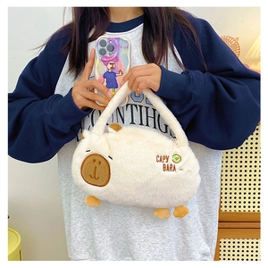 Detail of white plush capybara backpack featuring soft texture and cute embroidery