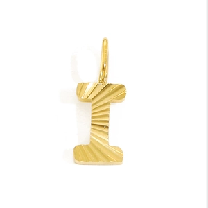 Detailed macro view of a gold letter I pendant with elegant sunburst texture detail