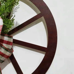 Rustic wooden wheel Christmas wreath with green pine branches and plaid bow decoration