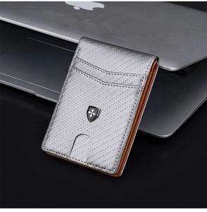 Close-up of gray RFID carbon fiber texture wallet on a desk with a sleek metal logo