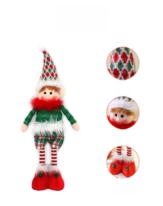 Detail showing plush fabric, festive face, and sequin decorations of the Christmas elf doll