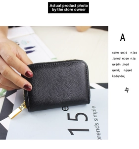 Close-up of black lychee grain leather card holder wallet with gold metal zipper