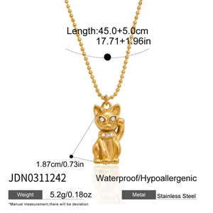 Detail view of 18K gold stainless steel Maneki Neko pendant with sparkling crystal inlay