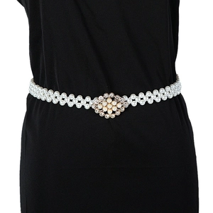Elegant white pearl waist chain for women with a gold flower buckle on black dress