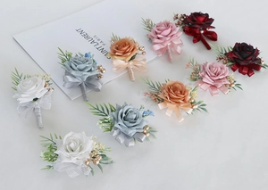 Detailed set of assorted artificial rose boutonnieres with satin ribbons and pearls