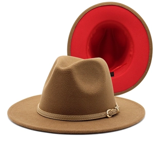 Detail of wool fedora hat with brown exterior, red interior, and khaki buckled leather band