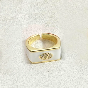 Detail of square gold ring featuring white enamel inlay and pave-set zircon evil eye