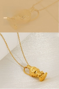 Detail of 3D Monkey King pendant with polished gold finish on a delicate link chain