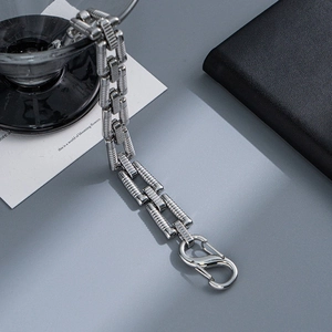 Close-up of textured stainless steel links and spring carabiner clasp for men jewelry