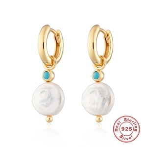 Detail of 925 silver gold earrings featuring turquoise beads and baroque pearls