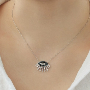 Macro detail of S925 sterling silver evil eye necklace with black enamel and white zircons