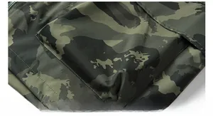 Detailed macro view of camo outdoor jacket with ripstop fabric and flap pocket detail