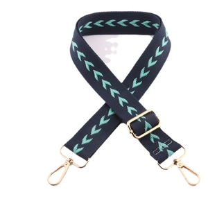 Adjustable navy blue woven shoulder strap with turquoise chevron patterns and gold hardware