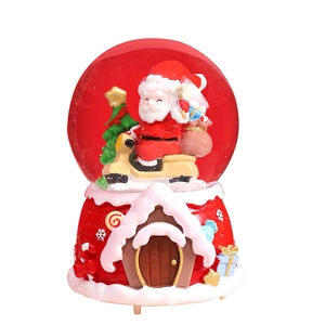 Christmas snow globe music box with Santa on scooter and red gingerbread house base