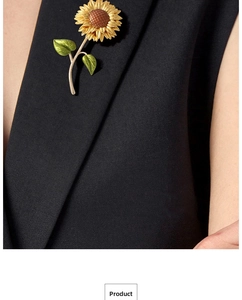 Macro detail of a vibrant sunflower enamel brooch pinned on a black textured blazer lapel