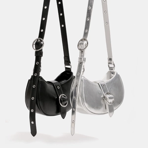 Minimalist half moon shoulder bags in black and silver finishes with adjustable metal buckle straps