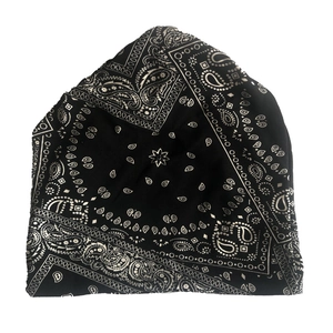 Detail showing paisley pattern on black knitted headwear with soft fabric texture