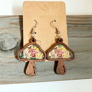 Handmade wooden mushroom earrings featuring real dried flowers embedded in clear resin