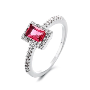 Luxurious silver ring with a rectangular red zircon and a sparkling pavé halo for women