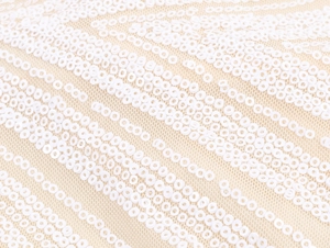 Macro shot of diagonal white sequins on beige mesh fabric for elegant dresses