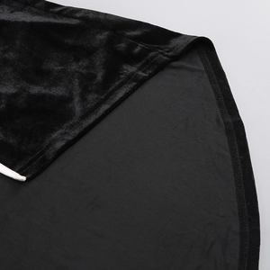 Detailed close-up of premium black velvet fabric texture and fine stitching on the dress