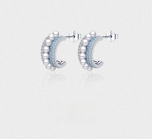 Gros plan de boucles d'oreilles en argent S925 avec perles et pierres turquoise