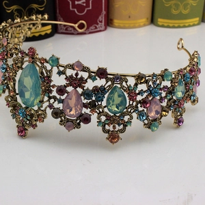 Macro shot of vintage gold crown featuring multicolored gemstones and ornate carvings