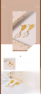 Detailed macro view of baroque pearl drop earrings with golden stainless steel leaf design