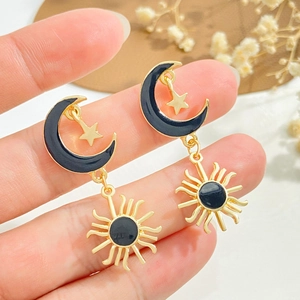 Vintage sun and moon drop earrings with black enamel detail in gold tone finish